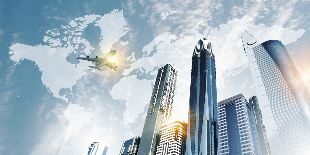 Plane flying above skyscrapers. Business travel concept